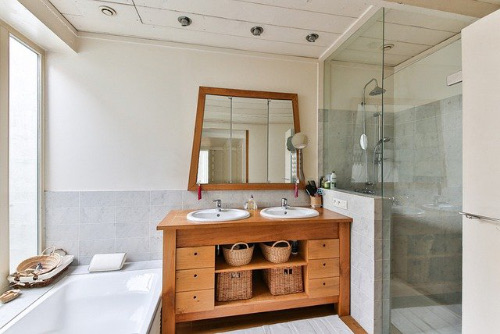 Bathroom with timber vanity and twin basins
